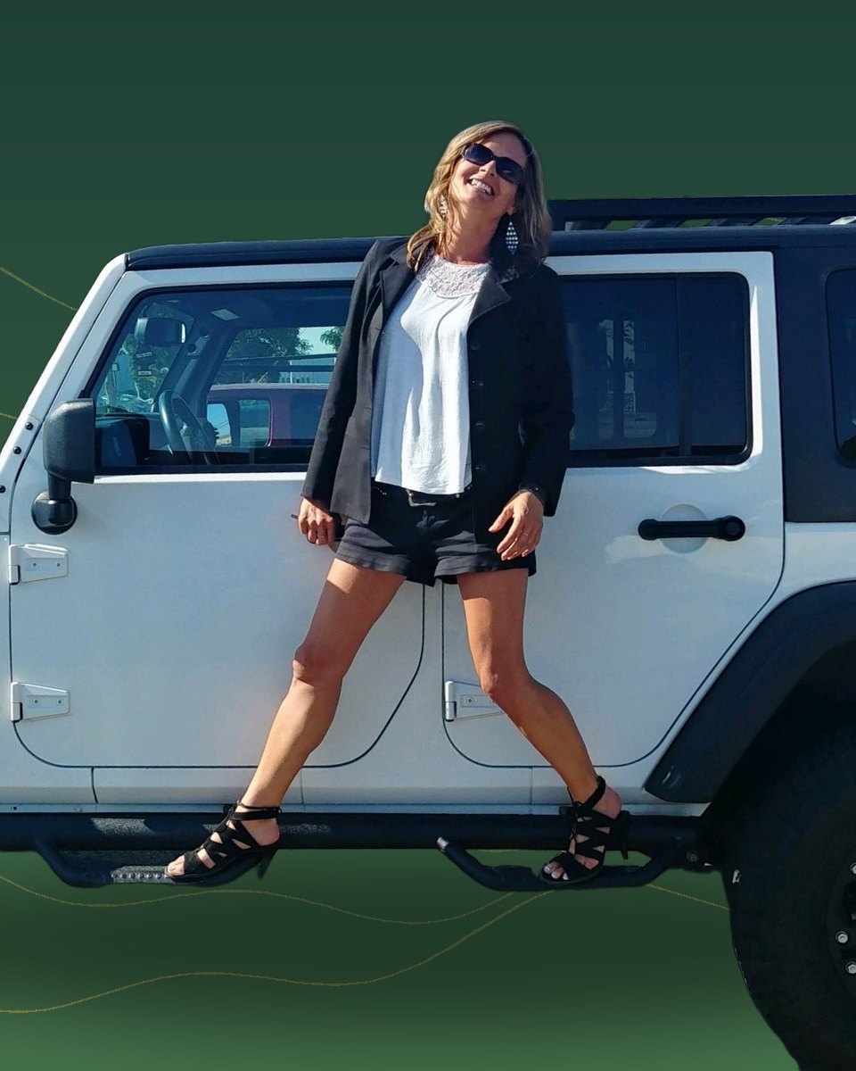 Becca Winston striking a pose on the running boards of a white Jeep